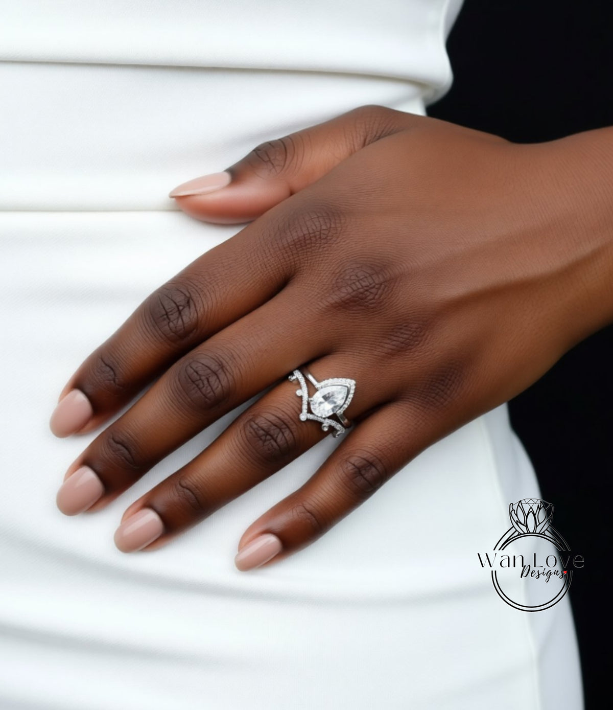 A close-up of a person's hand wearing a diamond engagement ring.