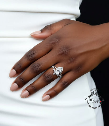 A close-up of a person's hand wearing a diamond engagement ring.