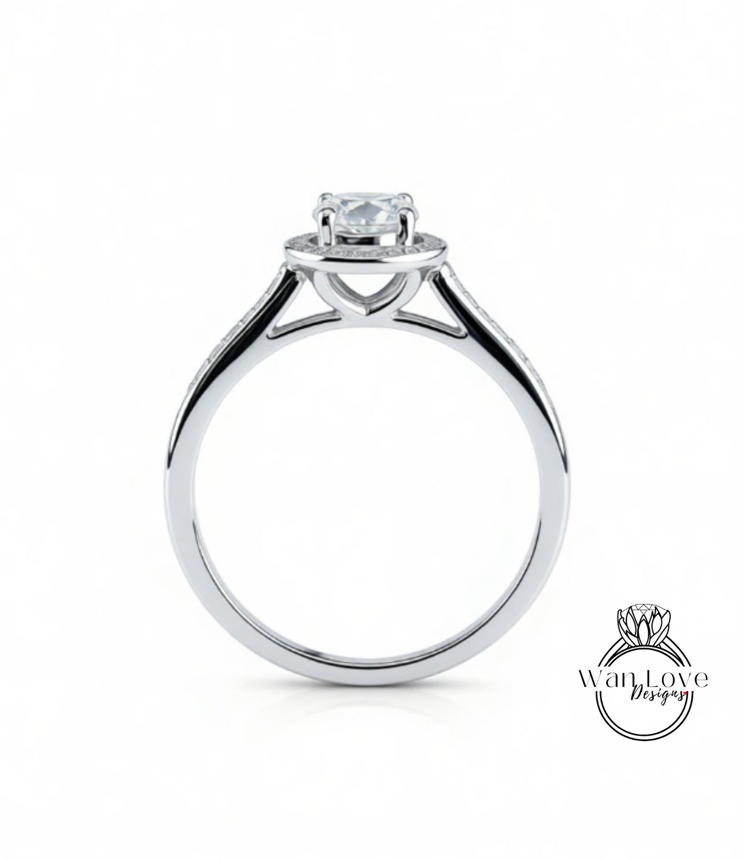 A silver engagement ring with a large central diamond and smaller diamonds on either side of the halo.