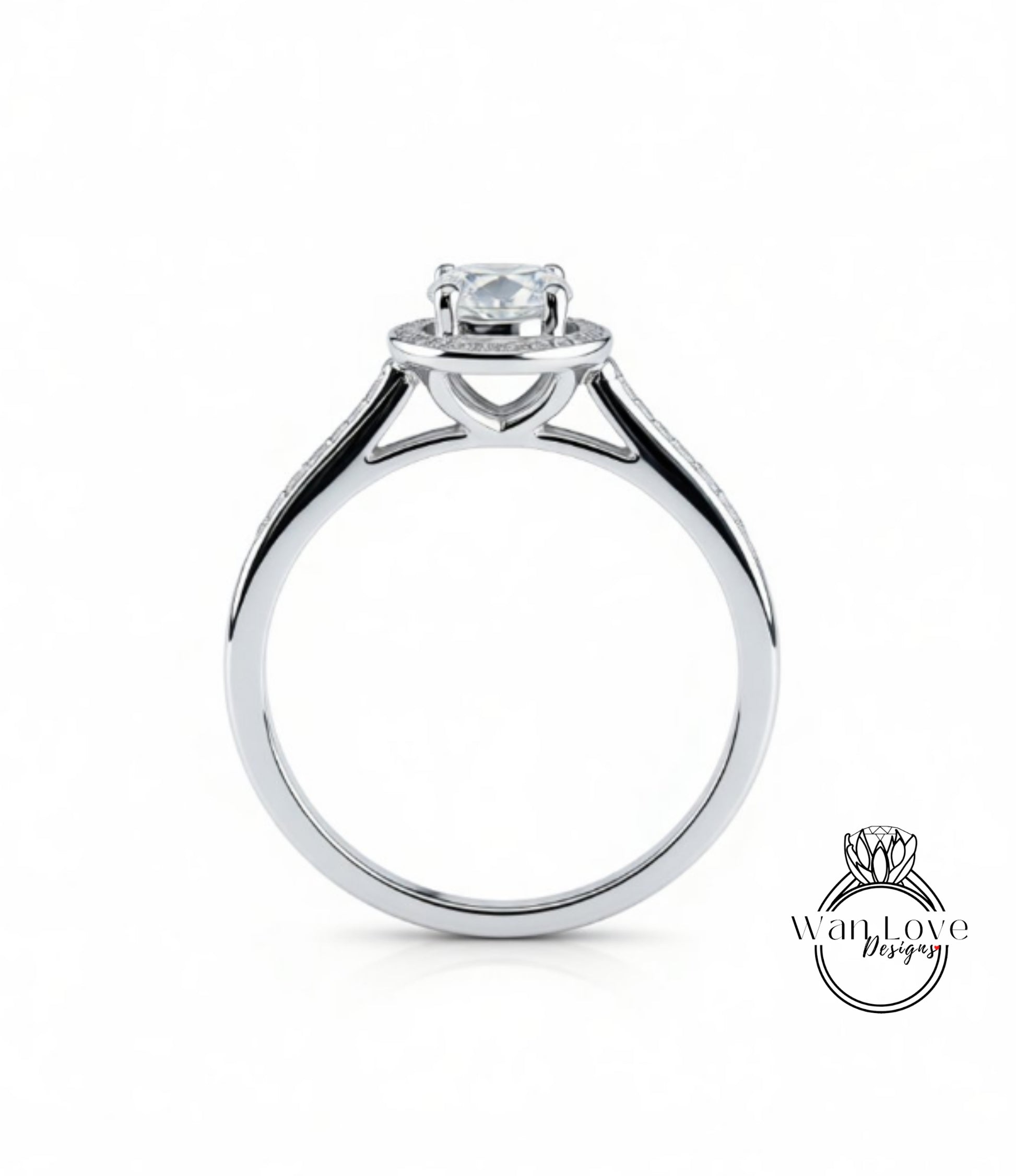 A silver engagement ring with a large central diamond and smaller diamonds on either side of the halo.
