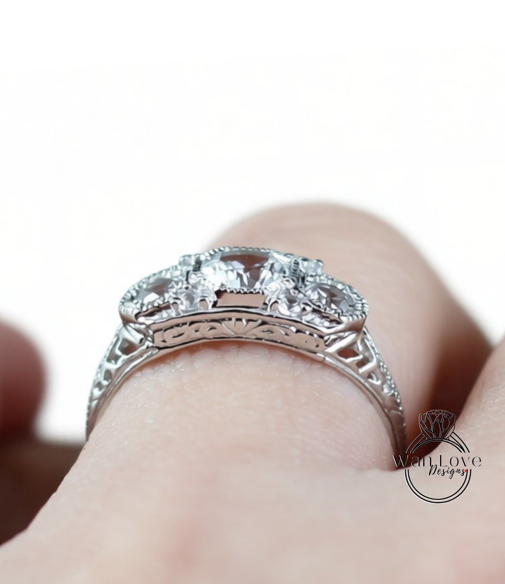 A close-up view of a silver ring with a large central gemstone surrounded by smaller stones.