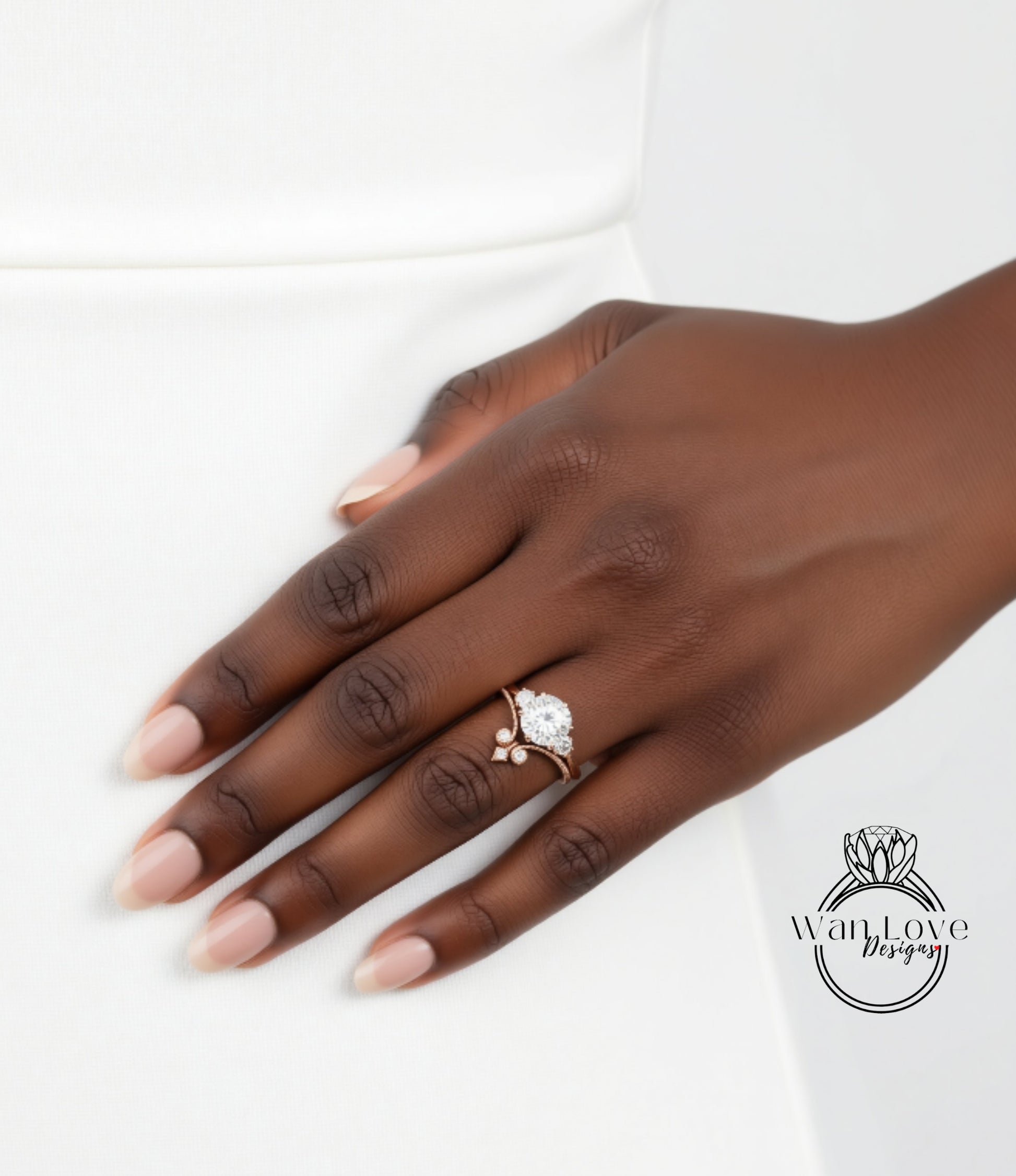 A close-up of a hand wearing a diamond engagement ring, with the ring's details visible.