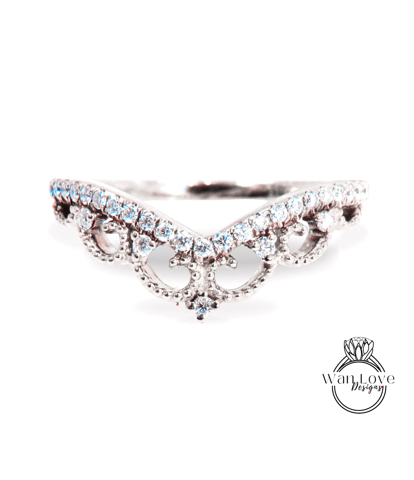 A close-up view of a diamond ring with a decorative band featuring a floral design.