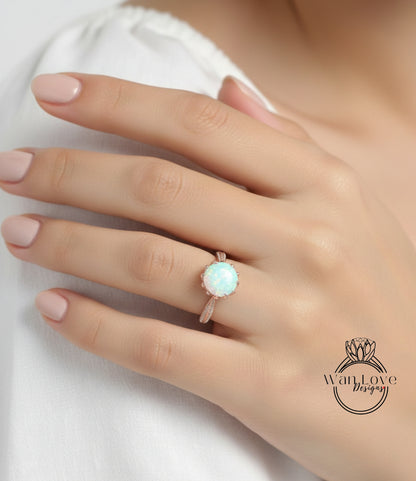 A close-up of a person's hand wearing a ring with a large, round opal stone.
