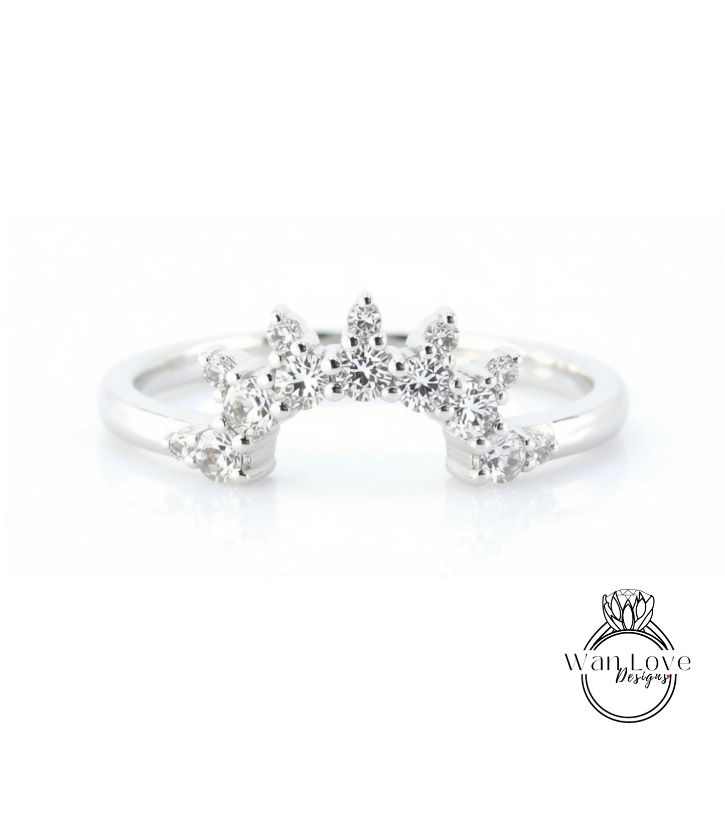 A silver ring with a large, sparkling diamond center stone surrounded by smaller diamonds, creating a radiant and elegant design.