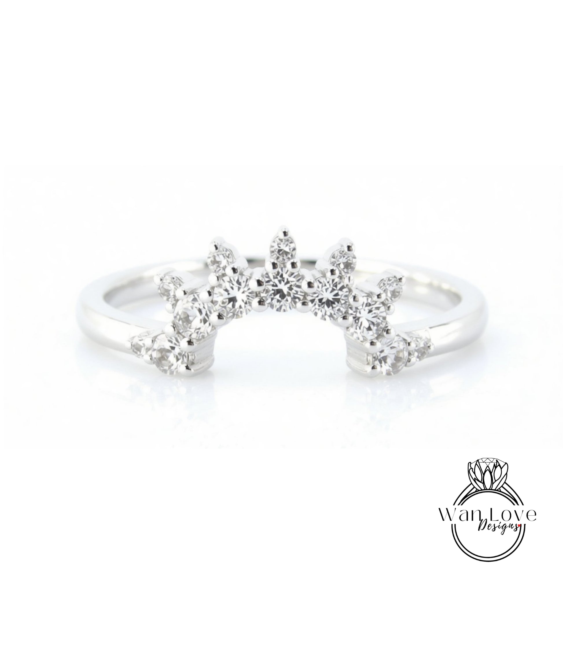 A silver ring with a large, sparkling diamond center stone surrounded by smaller diamonds, creating a radiant and elegant design.