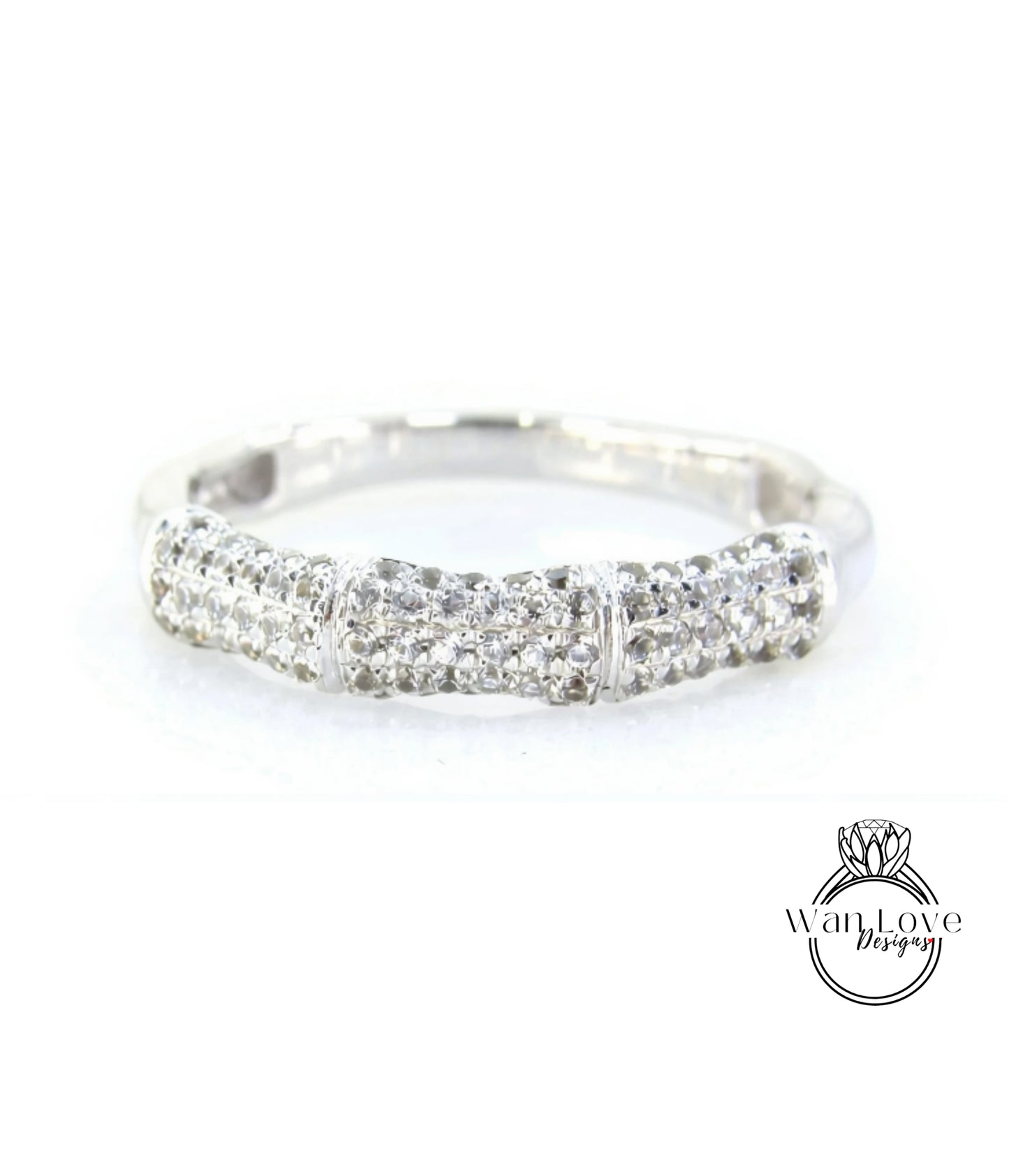 A silver ring with a row of small diamonds set in it.