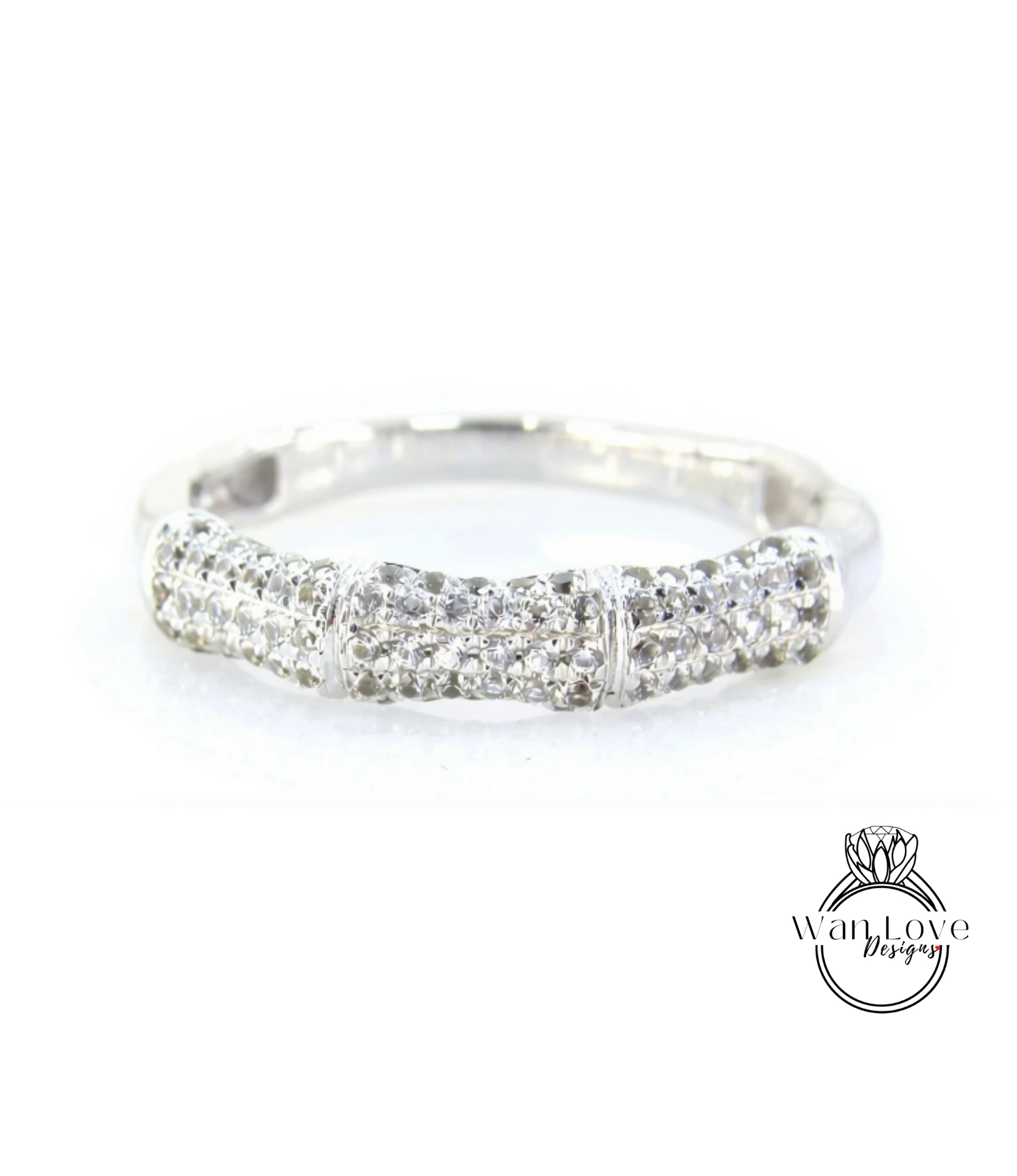 A silver ring with a row of small diamonds set in it.