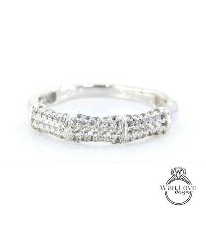 A silver ring with a row of small diamonds set in it.