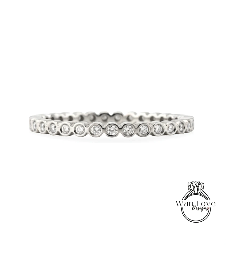 A silver band ring with a row of small diamonds set in the center.