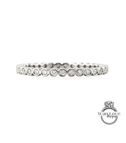 A silver band ring with a row of small diamonds set in the center.