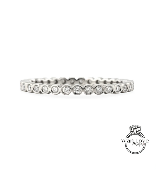 A silver band ring with a row of small diamonds set in the center.