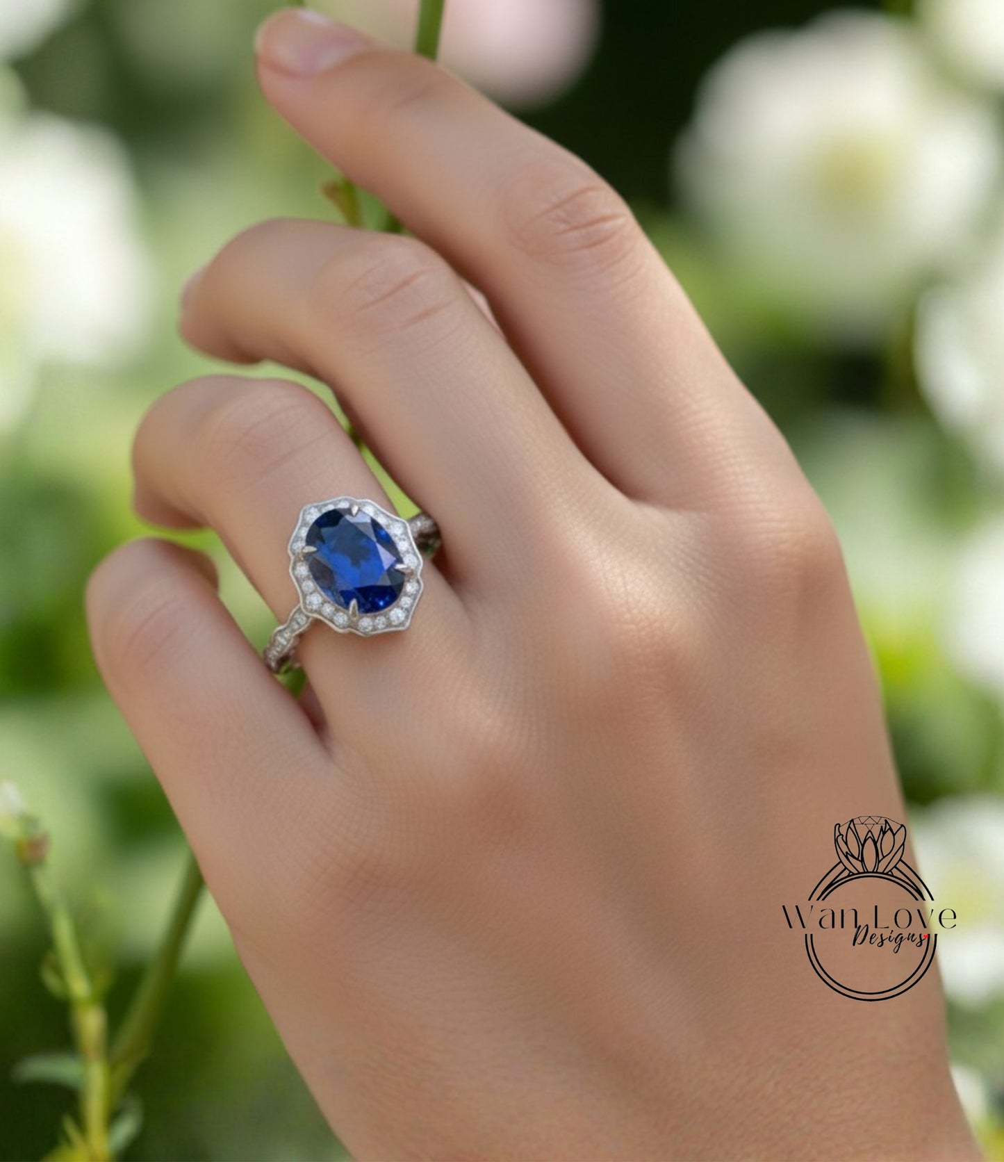 A close-up of a hand wearing a ring with a large blue gemstone, set in a silver band.