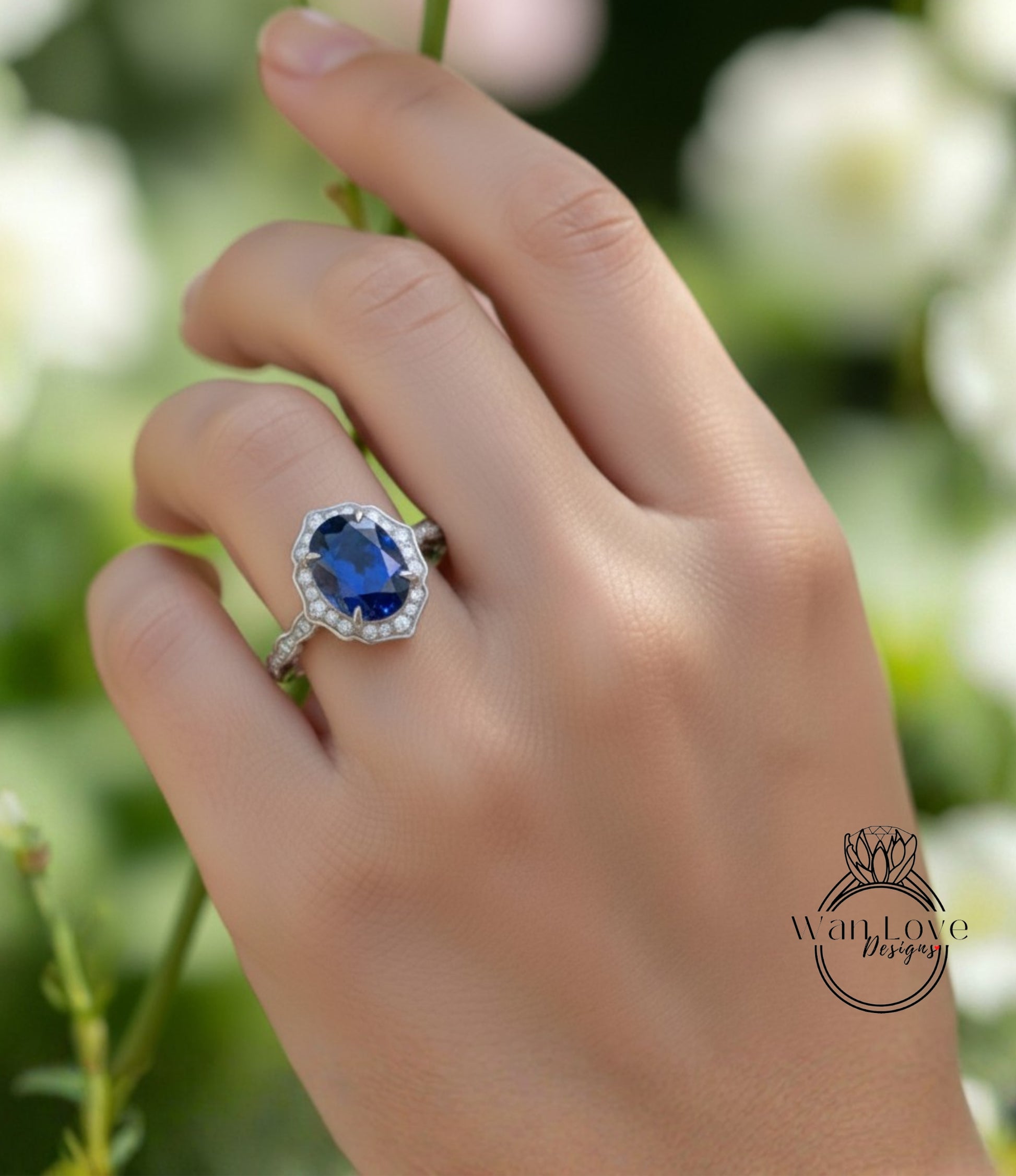 A close-up of a hand wearing a ring with a large blue gemstone, set in a silver band.