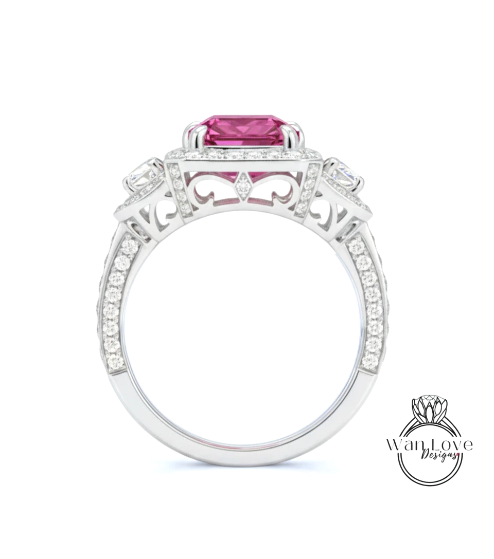 A close-up of a silver ring with a large pink gemstone, surrounded by smaller diamonds and intricate designs.