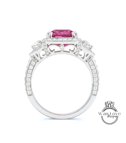 A close-up of a silver ring with a large pink gemstone, surrounded by smaller diamonds and intricate designs.