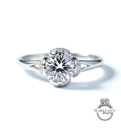 A close-up view of a diamond engagement ring with a large central diamond surrounded by smaller diamonds on the band.