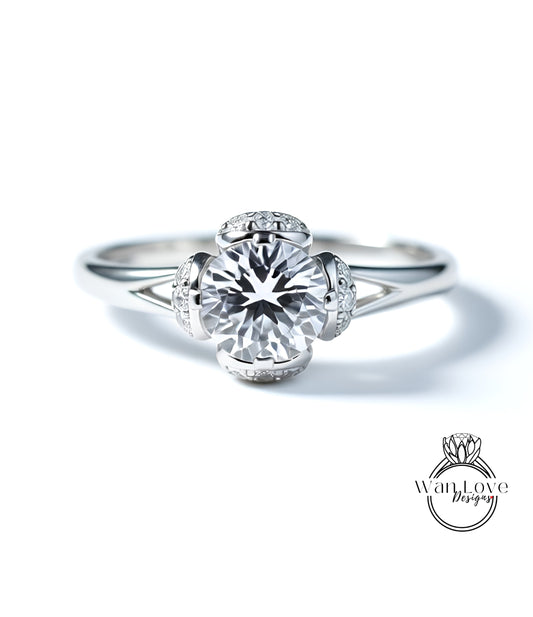 A close-up view of a diamond engagement ring with a large central diamond surrounded by smaller diamonds on the band.