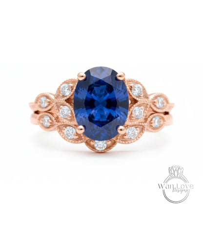 a beautiful blue sapphire engagement ring with a delicate rose gold band adorned with small diamonds.