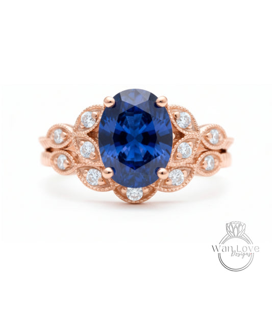 a beautiful blue sapphire engagement ring with a delicate rose gold band adorned with small diamonds.