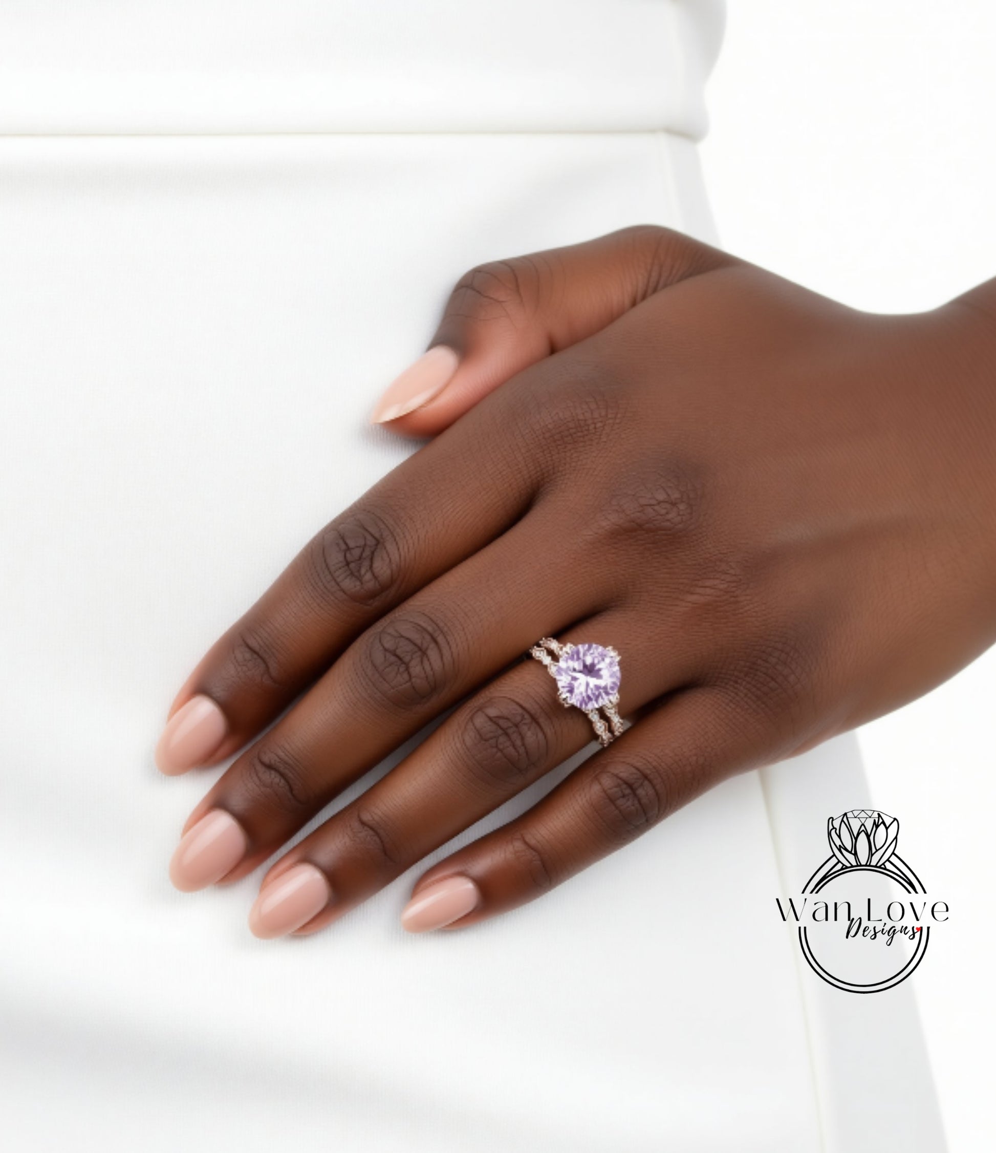 A close-up of a hand wearing a ring with a large purple gemstone.