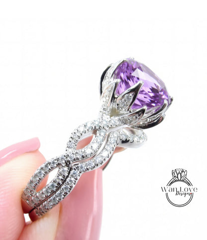 A close-up of a hand holding a diamond ring with a large purple gemstone.