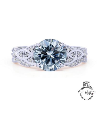 A stunning engagement ring with a large, brilliant blue diamond set in a silver band adorned with smaller diamonds.