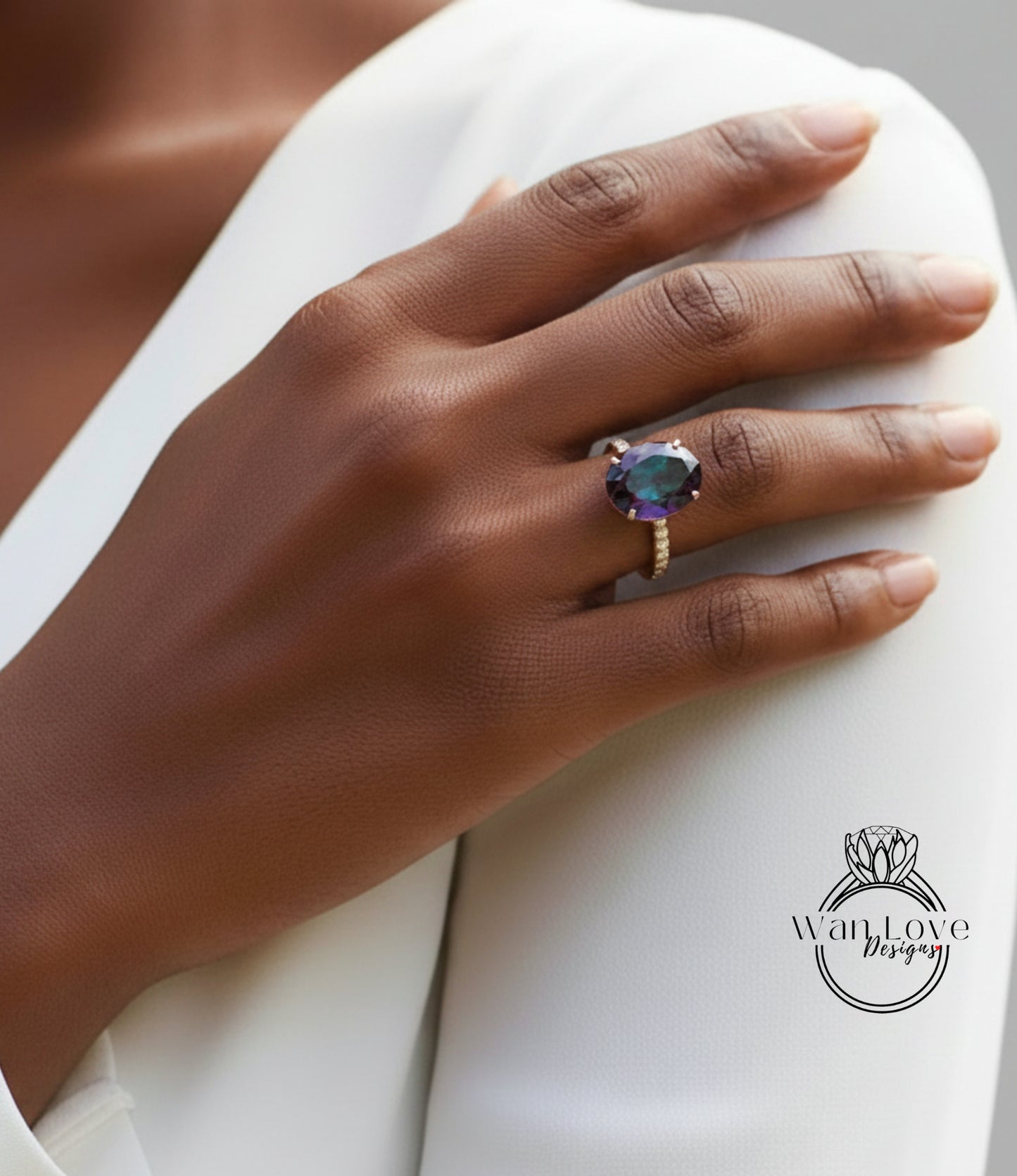 A close-up of a hand wearing a large, colorful gemstone ring on the ring finger.