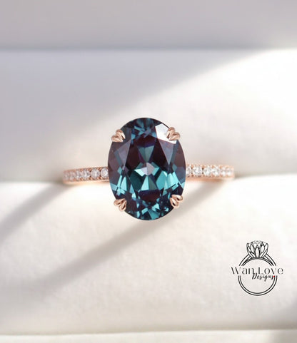 A close-up image of a rose gold ring with a large oval-shaped blue gemstone set in the center.