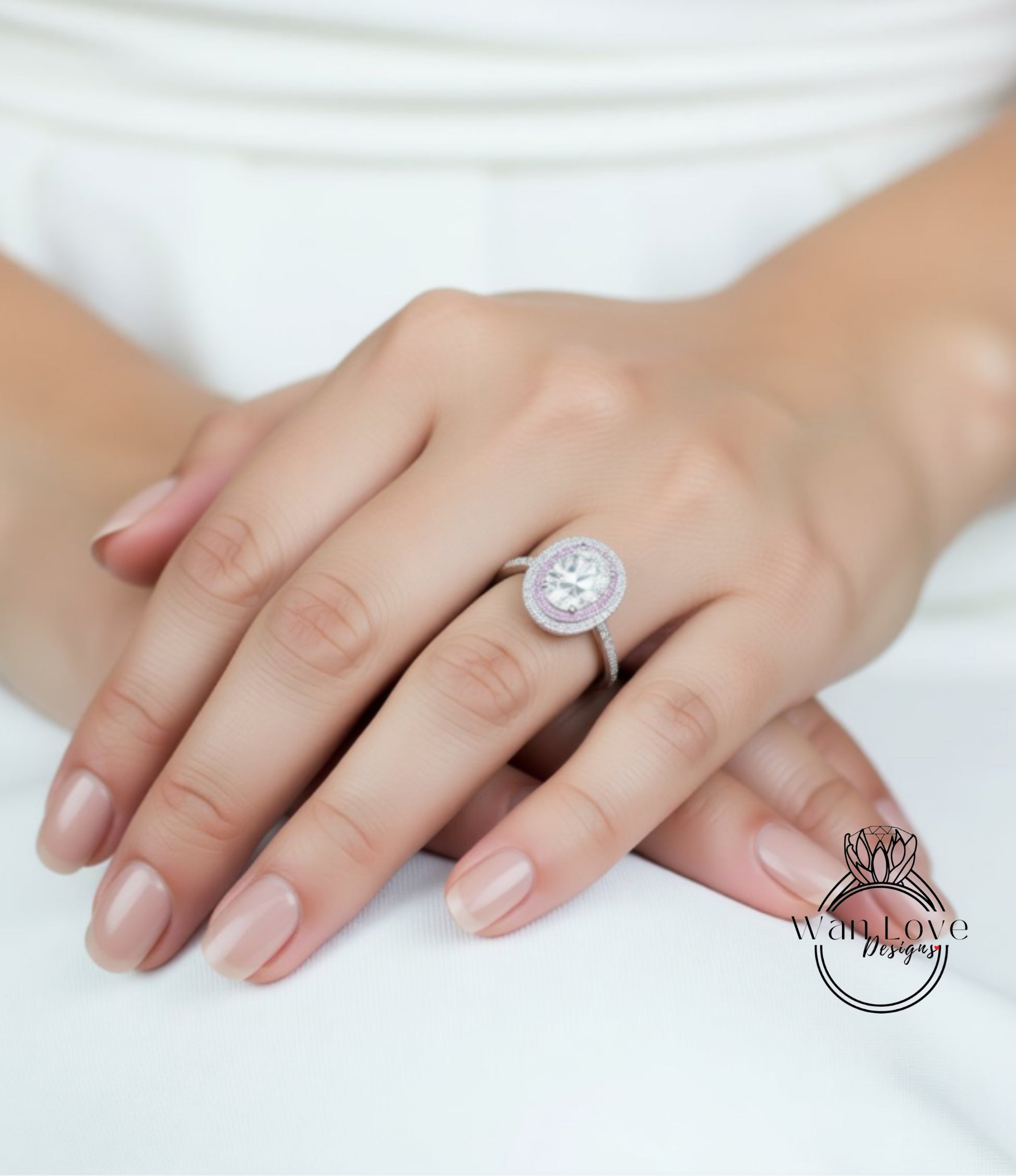 A close-up of a person's hand wearing a large, oval-shaped diamond ring on the ring finger.