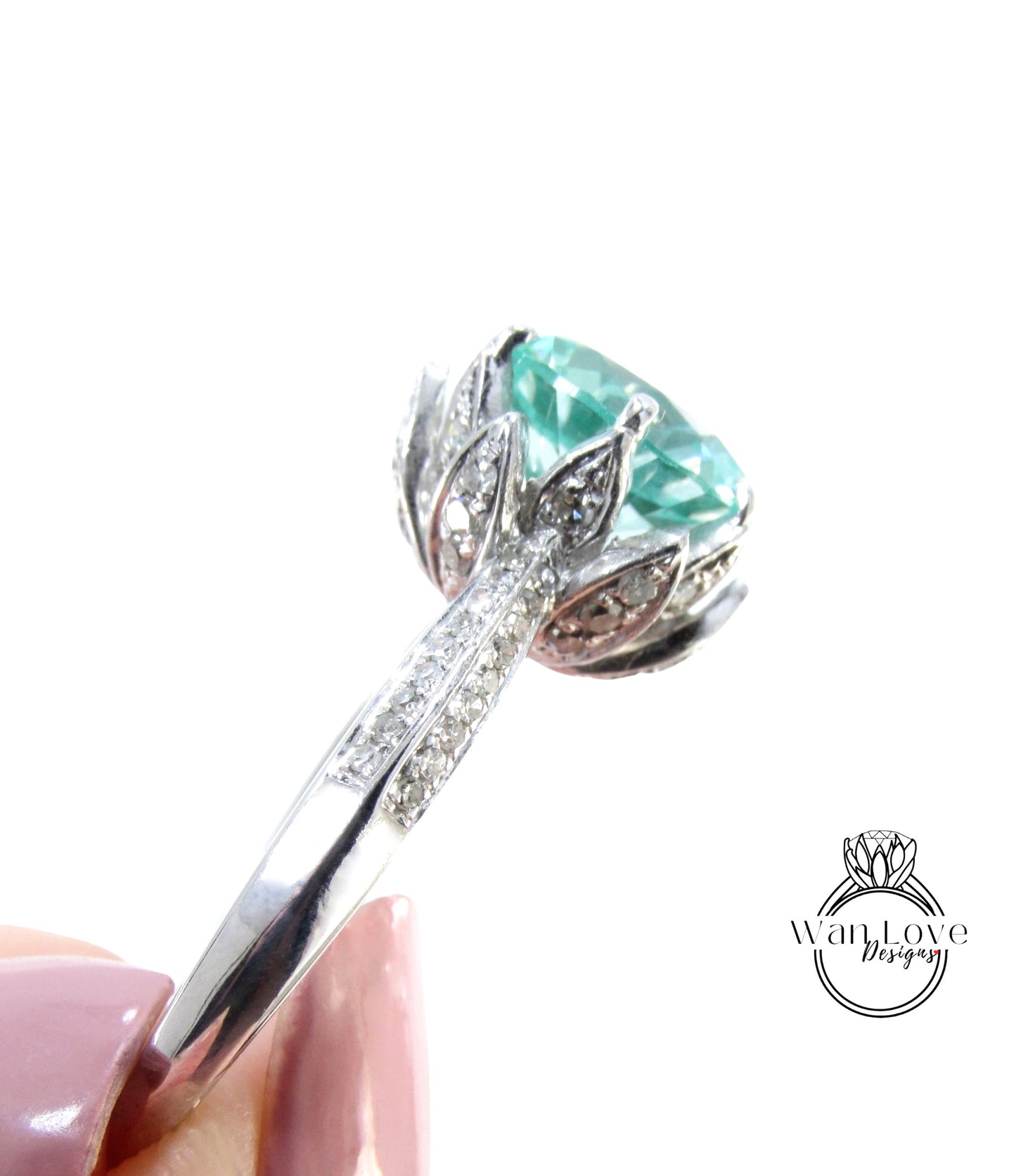 A close-up view of a silver ring with a large, turquoise gemstone, possibly a sapphire or similar type of blue gemstone.