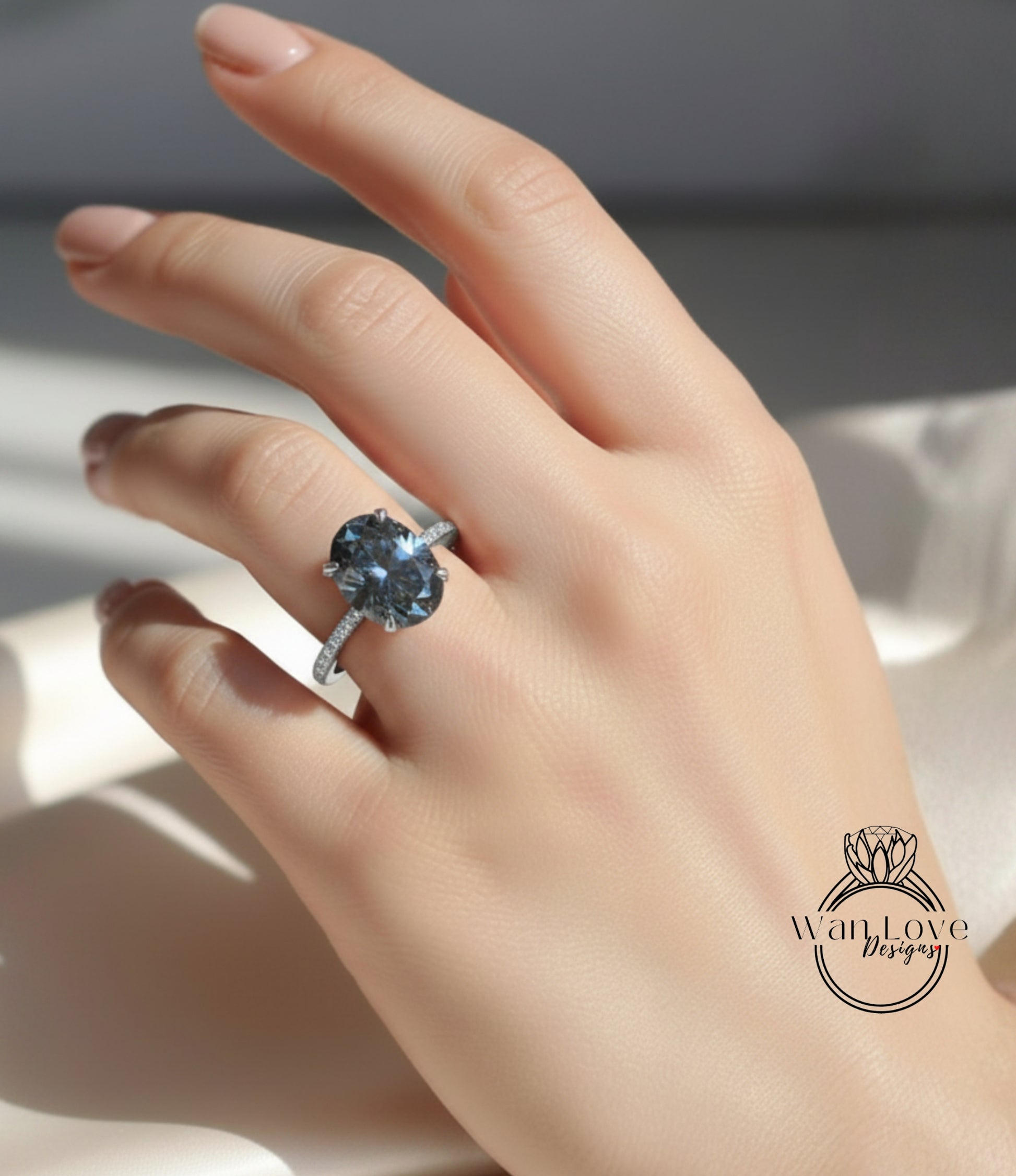 A close-up of a hand wearing a large blue gemstone ring with a diamond band.
