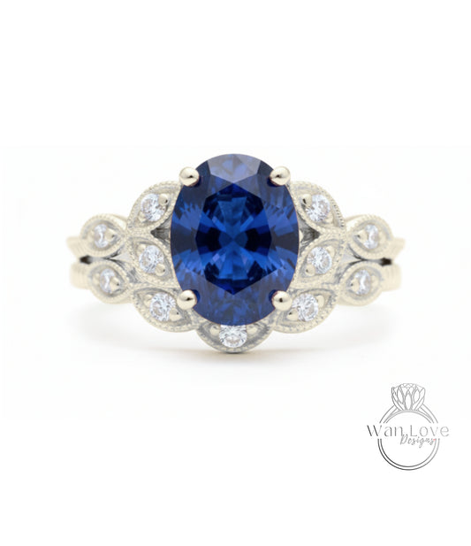 A close-up of a diamond engagement ring with a large oval-shaped blue gemstone surrounded by smaller diamonds.