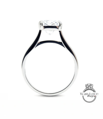 A silver engagement ring with a large central diamond.