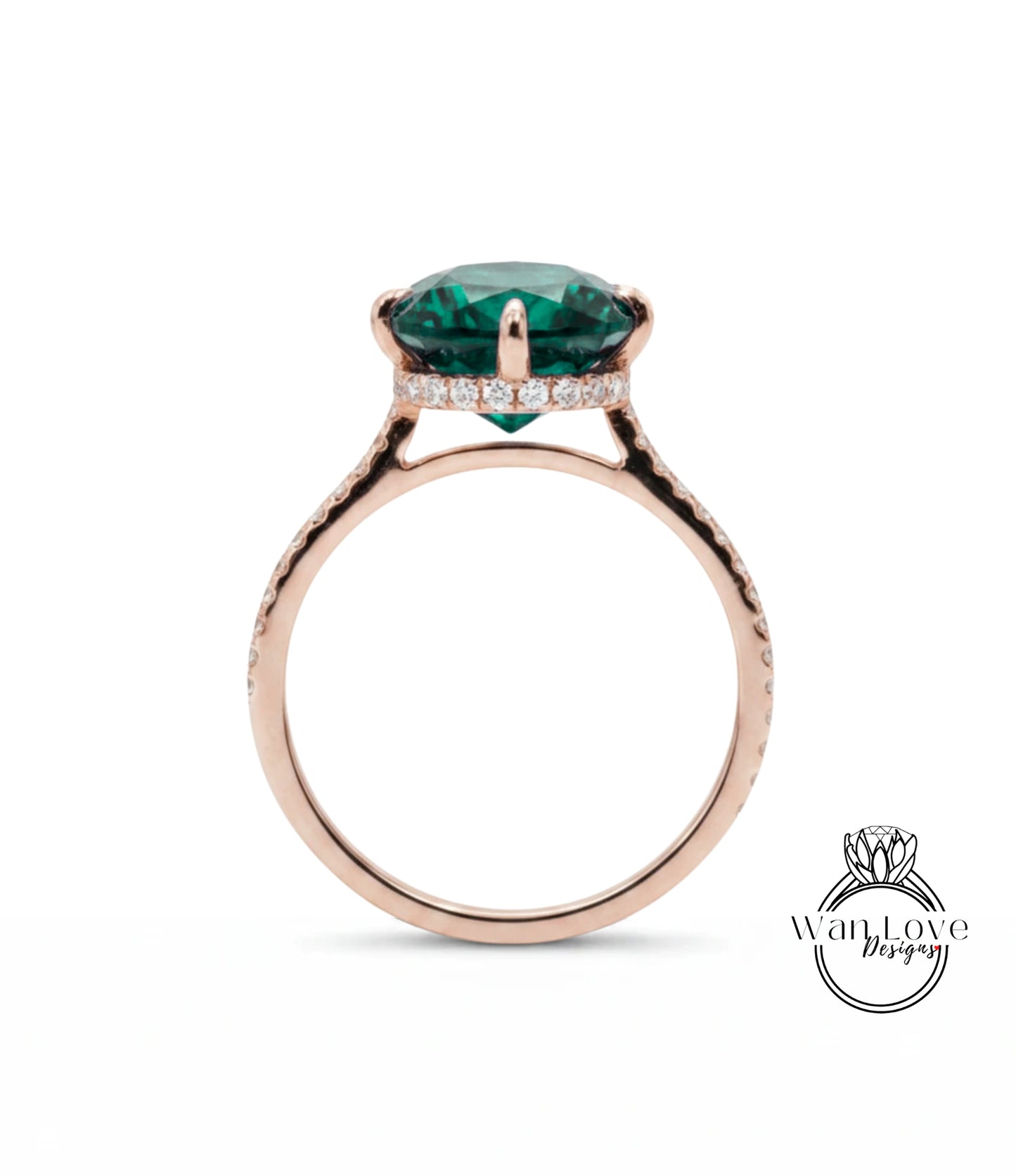 A rose gold ring with a large, green gemstone set in the center.