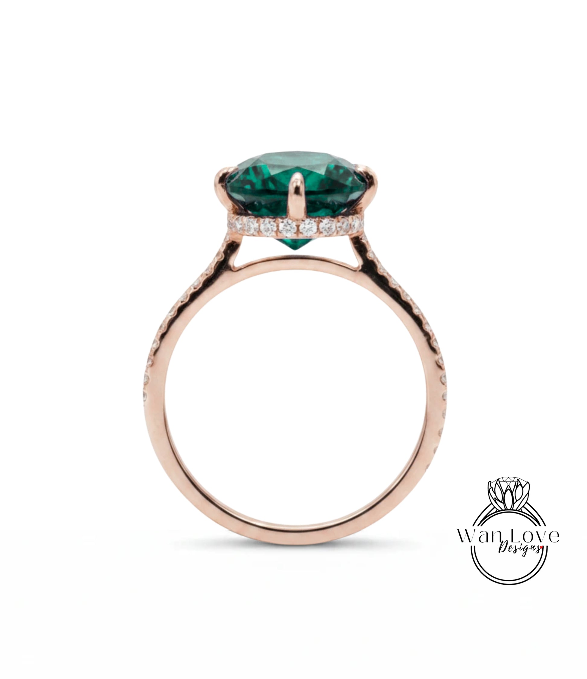A rose gold ring with a large, green gemstone set in the center.