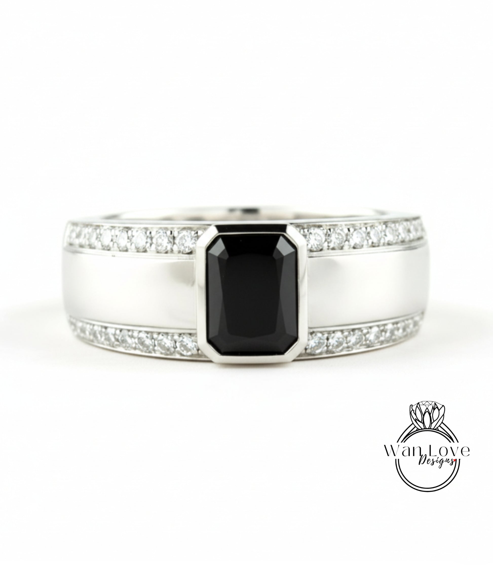 A silver ring with a large black gemstone in the center, surrounded by smaller diamonds.