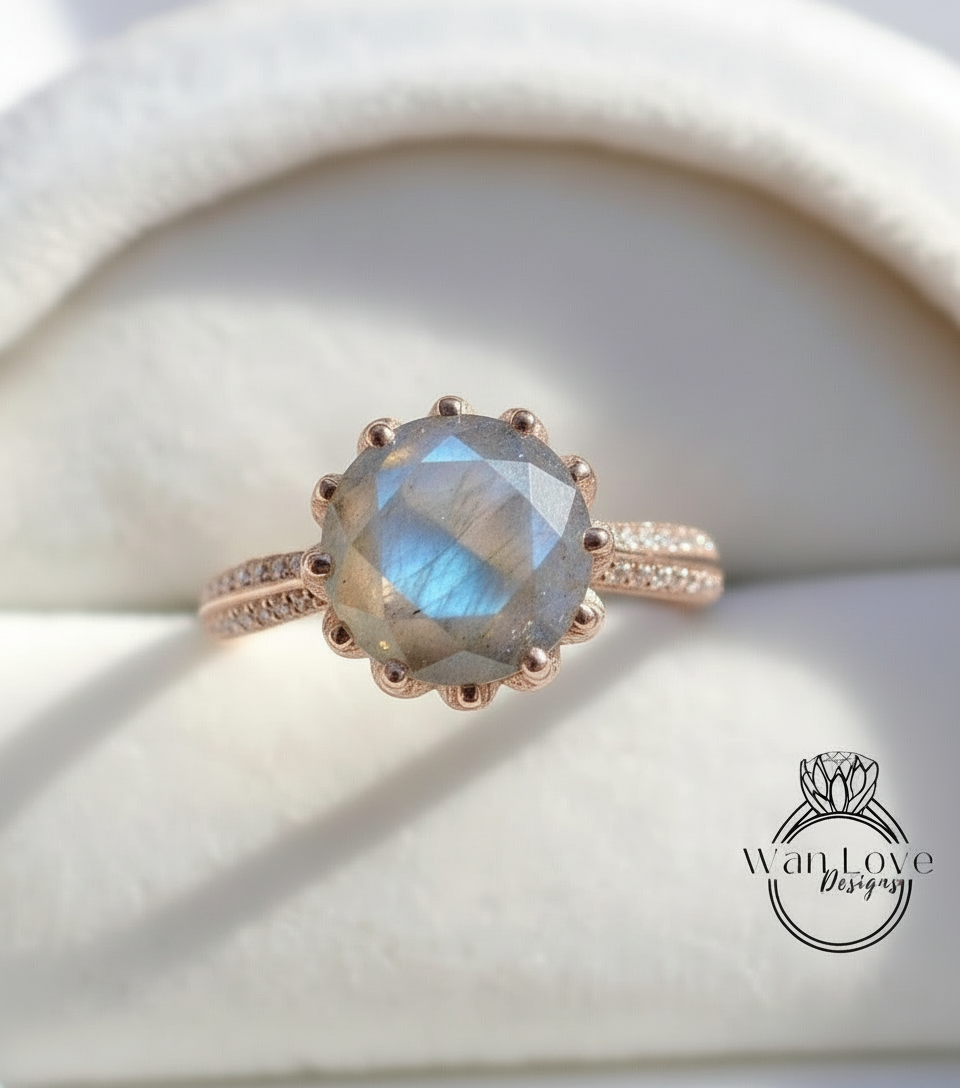 A close-up image of a rose gold ring with a large, round blue gemstone set in the center, surrounded by smaller diamonds.