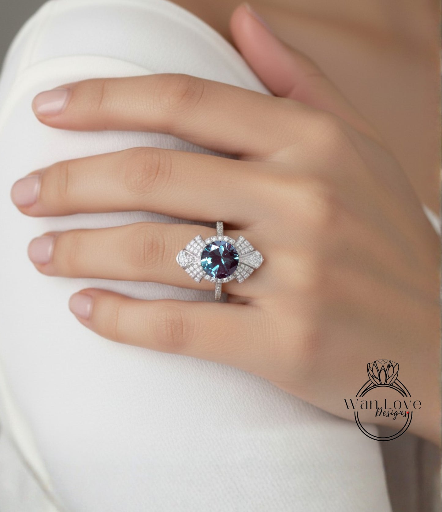 A close-up of a hand wearing a large, ornate ring with a blue gemstone.