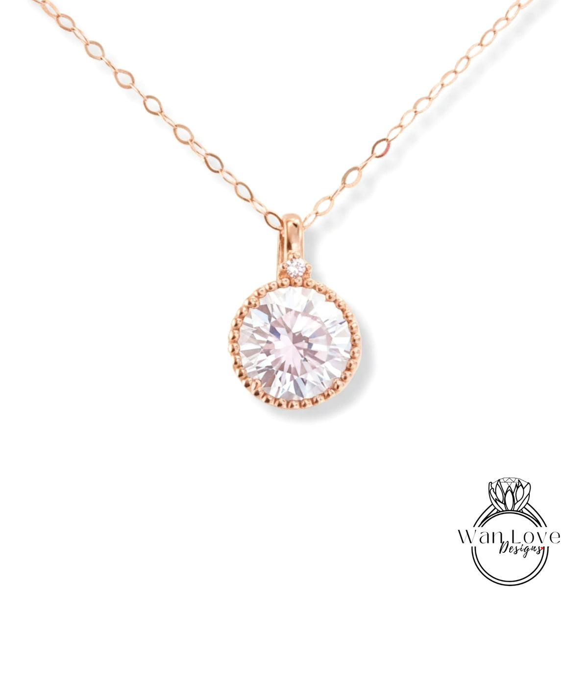 A delicate rose gold necklace with a large, round, clear gemstone pendant.