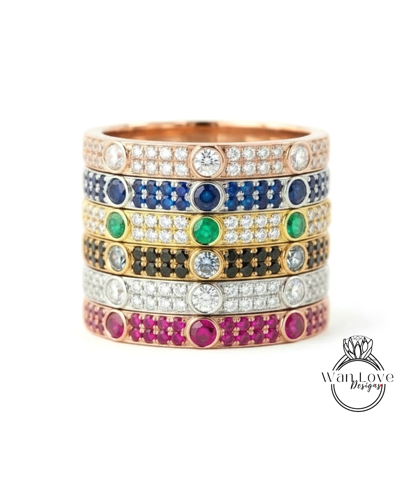 A stack of rings with various colored gemstones and diamonds set in a gold band.