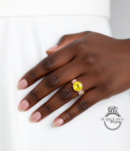 A close-up of a hand wearing a yellow gemstone ring on the ring finger.