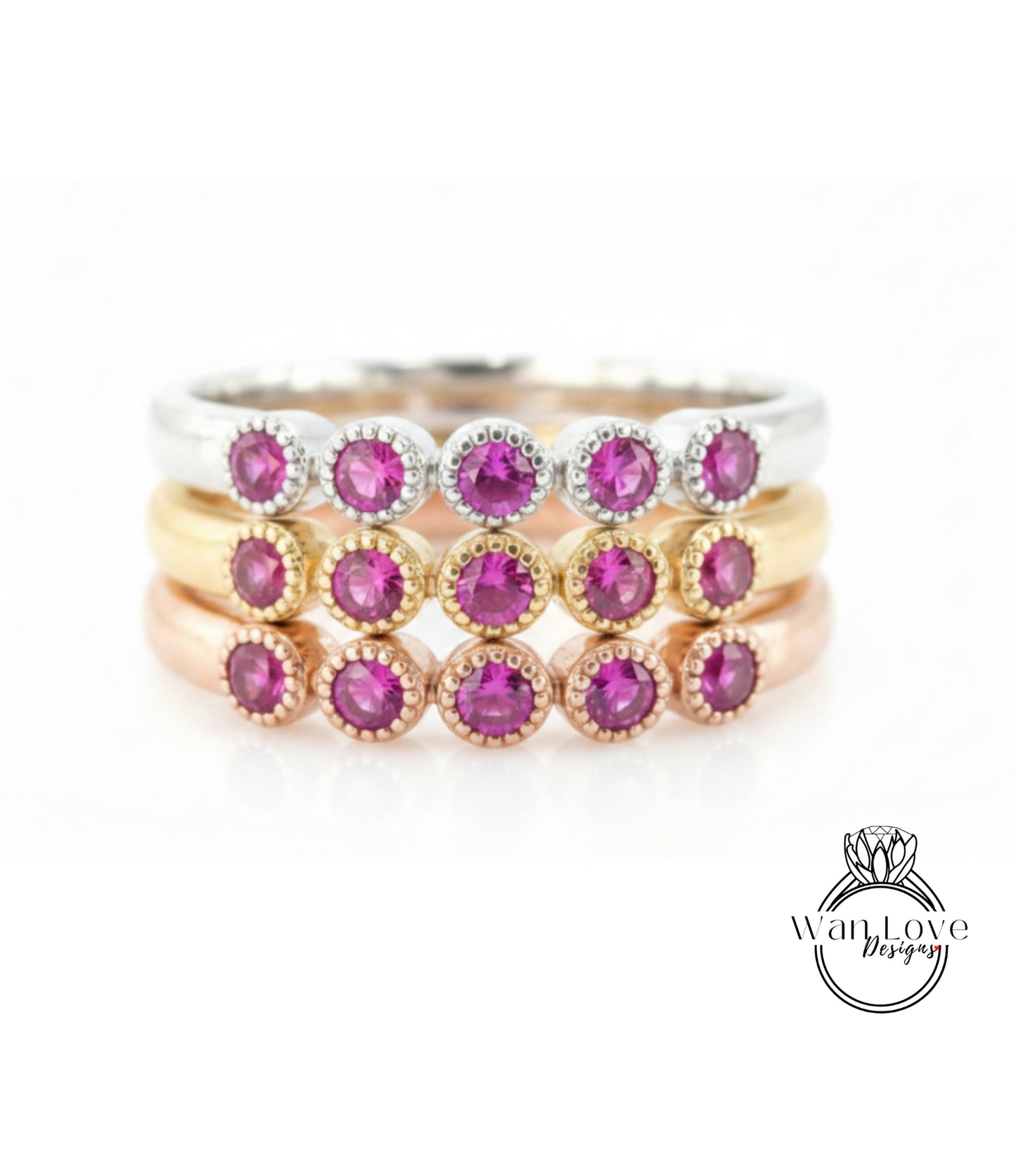 A ring with multiple layers of rings, each ring featuring a small, round, purple gemstone.
