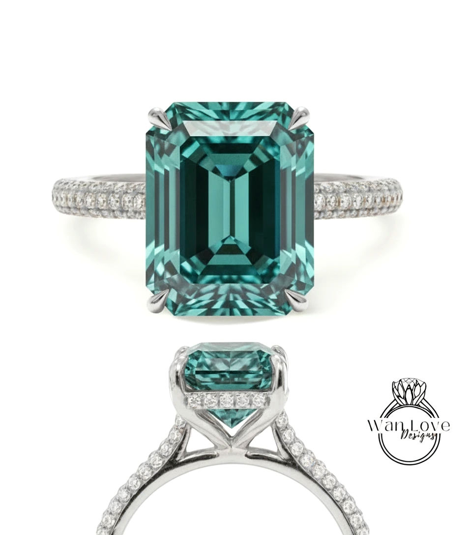 A stunning engagement ring with a large, vibrant green gemstone set in a silver band adorned with small diamonds.