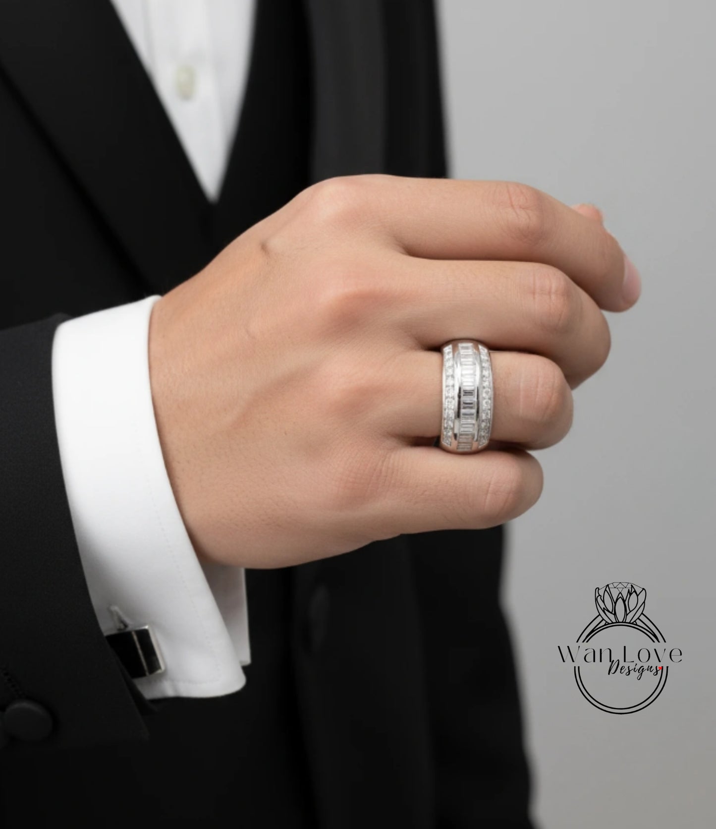 A close-up of a person's hand wearing a large, ornate ring on the ring finger.