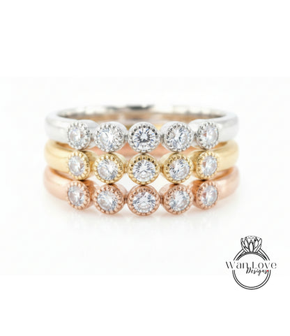 A ring with multiple tiers of rings, each ring featuring a diamond. The rings are arranged in a layered fashion, with the topmost ring being the largest and the bottommost ring being the smallest.