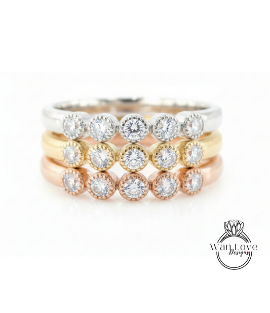 A ring with multiple tiers of rings, each ring featuring a diamond. The rings are arranged in a layered fashion, with the topmost ring being the largest and the bottommost ring being the smallest.
