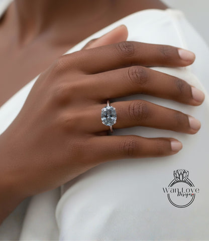 A close-up of a hand wearing a large diamond ring on the ring finger.