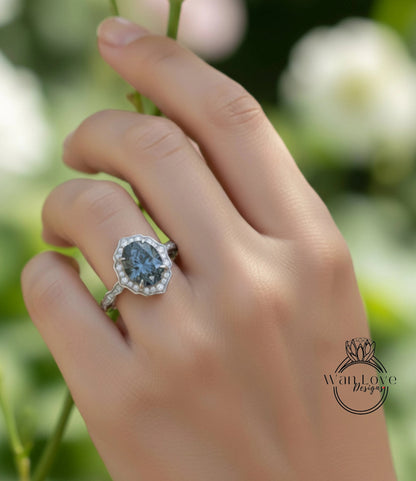 A close-up of a hand wearing a diamond ring with a large oval-shaped gemstone.