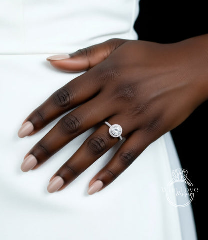 A close-up of a hand wearing a diamond engagement ring.